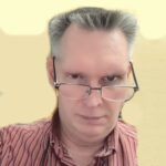 Bill with stern look in glasses